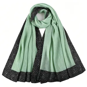 Pleated long scarf with black dotted border and mint green fabric details close-up view.