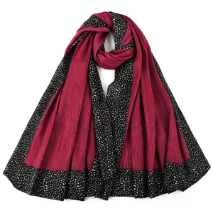 Pleated long scarf detail showing red fabric with black dotted pattern border, elegant texture.
