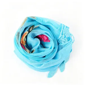 Light blue embroidered lace mesh scarf detail showcasing elegant floral patterns and soft drape.