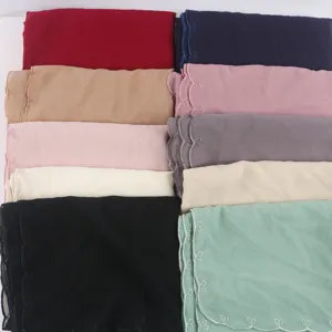 Detailed view of colorful chiffon scarves with delicate lace embroidery trim for women.