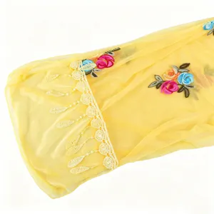Yellow sheer floral embroidered scarf detail showing delicate lace trim and lightweight fabric.