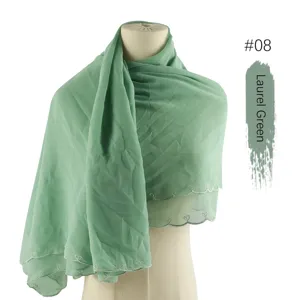 Close up view of laurel green chiffon hijab scarf with delicate heart embroidery details.