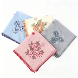 Detailed view of women elegant scalloped embroidered scarf featuring delicate pearl floral accents.