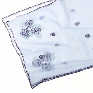 Light blue sheer embroidered scarf with pearl floral design and elegant scalloped edge.