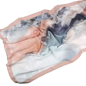 Detailed view of a fashionable printed chiffon scarf with abstract watercolor pattern and pink border.
