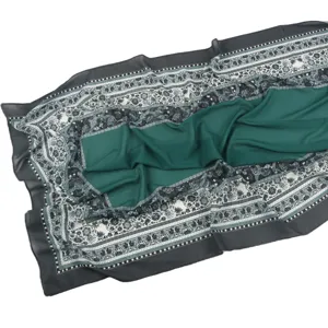 Close-up detail of the elegant printed chiffon hijab scarf featuring a floral border and green center.
