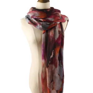 Detailed close-up view of the artistic tie-dye pattern women scarf on mannequin display.