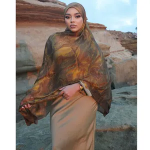 Detailed view of women's stylish marbled silk hijab scarf, elegant outdoor fashion wear.