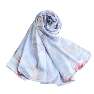 Exquisite blue floral print silk scarf detail, elegant lightweight summer accessory.