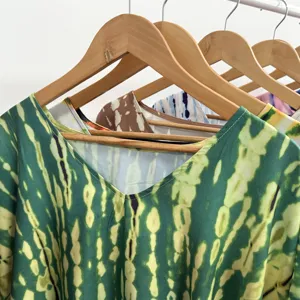 Detailed view of the V-neck tie-dye beach cover-up vacation robe, featuring vibrant green hues.
