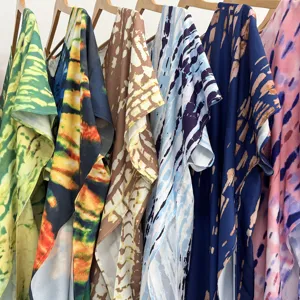 Close-up of bohemian tie-dye beach cover-ups, showing vibrant patterns and relaxed fit.