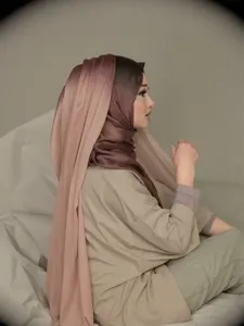 Detail view of a gradient modal cotton hijab, soft draped long scarf in elegant brown tones.