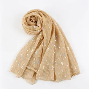 Detailed close-up of the shimmering metallic pleated fabric, showcasing the delicate sequin circles.