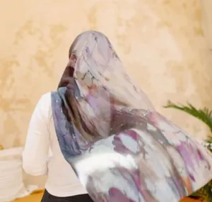 Detailed view of women satin polyester tie-dye long scarf elegant Turkish hijab style.
