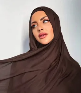 Close-up detail of the breathable solid brown modal hijab scarf showing soft fabric texture.