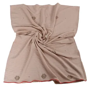 Details of the elegant beige rhinestone mercerized cotton scarf featuring delicate red edge trim.