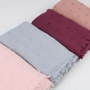 Lightweight breathable linen scarf, wrinkled pom-pom design, raw edge detail for elegant styling.