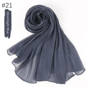 Detailed view of the solid color crinkled silk scarf showcasing its smooth texture and drape.