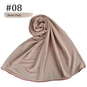 Detailed view of the sheer pink striped mercerized cotton hijab with delicate red edge.