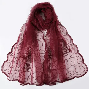 Burgundy sheer embroidered floral scarf detail close-up, elegant lightweight shawl fabric.
