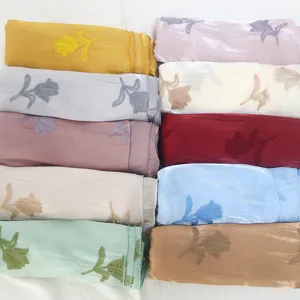 Detailed view of women's smooth silk feel scarf with delicate floral embroidery design.
