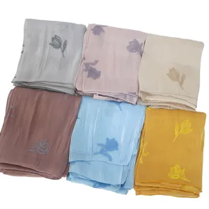 Detailed view of high-quality embroidered island silk long scarves featuring delicate tulip motifs.