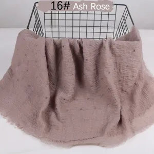 Ash Rose textured crinkle cotton linen scarf detail showing delicate raw edges and cute pom poms.