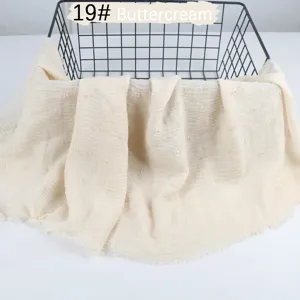 Solid color breathable cotton linen scarf with crinkle tassel design for women daily wear.