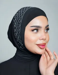 Closeup detail of black rhinestone turban cap featuring sparkling crystal mesh pattern.