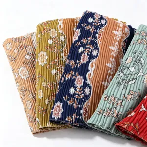 Detailed view of fashionable printed pleated long scarf and hijab in vibrant multicolor floral design.