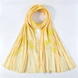 Detail view of the crinkle chiffon embroidered long scarf with metallic yarn and floral pattern.
