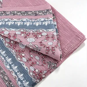 Detailed view of a pleated floral long scarf hijab, showing soft fabric texture and print.