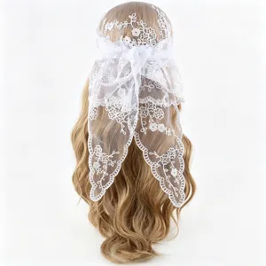 Close-up view of the delicate white floral lace headscarf tied gracefully on the back.