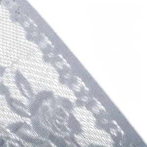 Detail view of light blue floral lace fabric, delicate hollow mesh design for chic wedding veil.