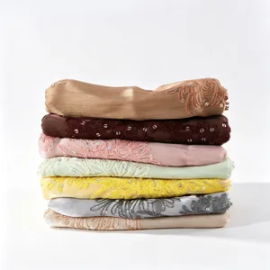 Detailed close-up showing exquisite embroidery and delicate sequins on pleated scarf fabric.
