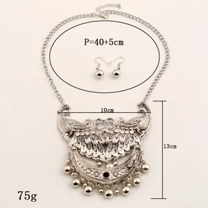 Vintage silver peacock pendant necklace and earrings set with rhinestones and tassels.
