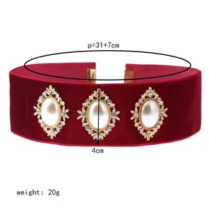 Vintage velvet choker necklace detail showing pearl rhinestone centerpiece and length.