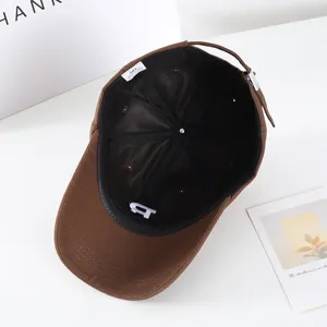 Cappellino da baseball marrone con fodera interna, etichetta e ricamo dettagliato.