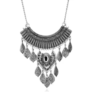 Detailed view of vintage silver statement necklace featuring intricate leaf carvings and dangles.