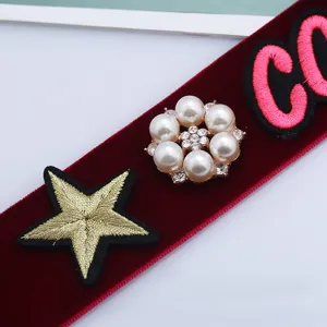 Detailed close-up of European retro velvet choker with pearl embroidery and star patch.