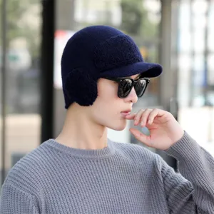 Detail view of men's winter knitted bomber hat with earflaps and visor in dark blue.