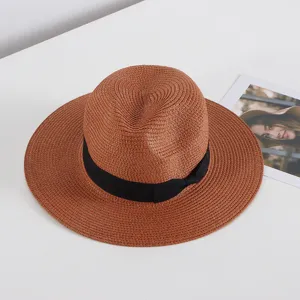 Vista detallada de un sombrero de paja marrón con cinta negra, ideal para la protección solar.