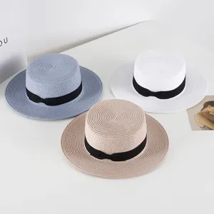 Summer flat top straw hat for women with black ribbon bow, stylish beach sun protection cap.