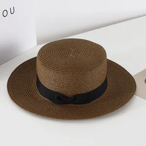 Chic brown flat top straw hat with black ribbon bow, vintage British style sun protection beach hat.