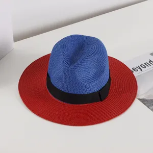 Detailed view of the stylish blue and red straw fedora hat with black ribbon for summer beach.