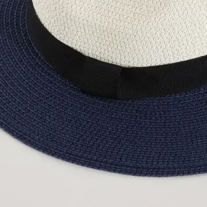 Detailed view of the summer straw hat showing fine woven texture, classic black ribbon.