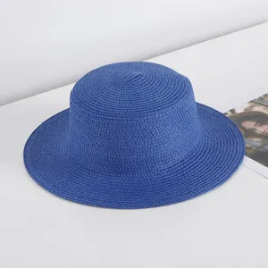 Blue flat top straw hat detail view, perfect for summer beach vacation sun protection.
