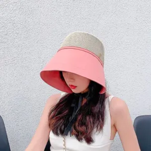 Stylish women's sun protection bucket hat with wide pink brim and breathable mesh crown.