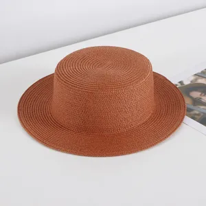Brown flat top straw hat detailed view, ideal for summer beach sun protection and outdoor travel.