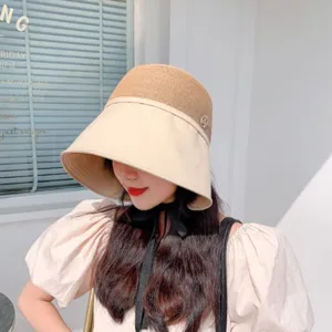 Color-blocked bucket hat with rhinestone emblem, stylish sun protection beach hat for summer.